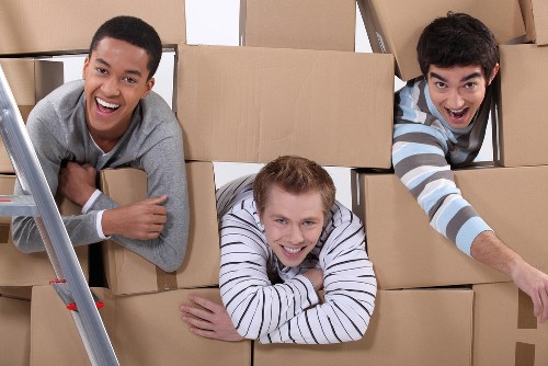 Professional packers working in a Knightsbridge home with boxes and protective wrapping