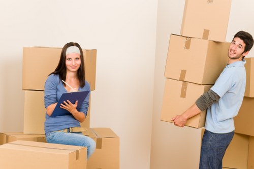 Furniture being moved through a central London flat building with stair access
